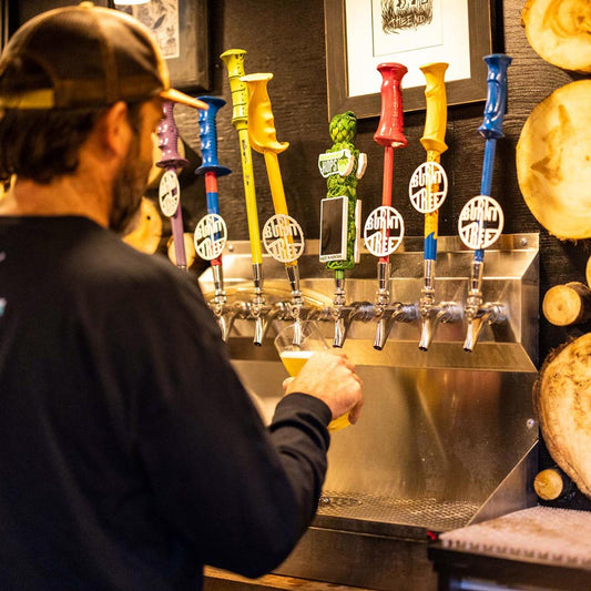 Bartender pouring draft from one of the Burnt Tree taps