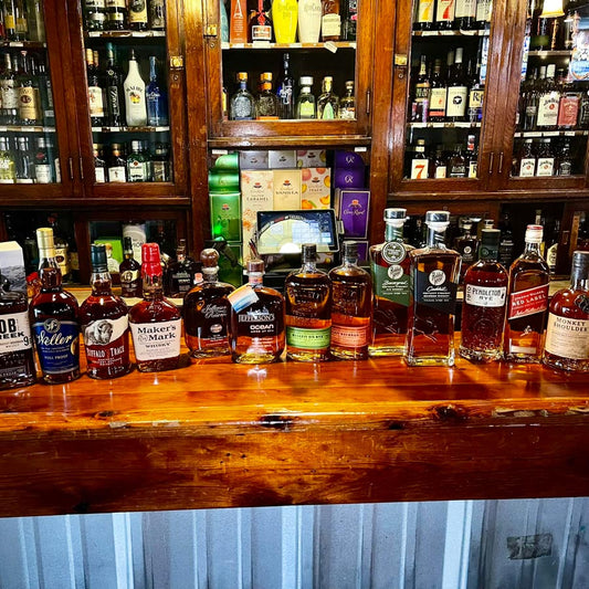 Large assortment of whiskey on bar counter 